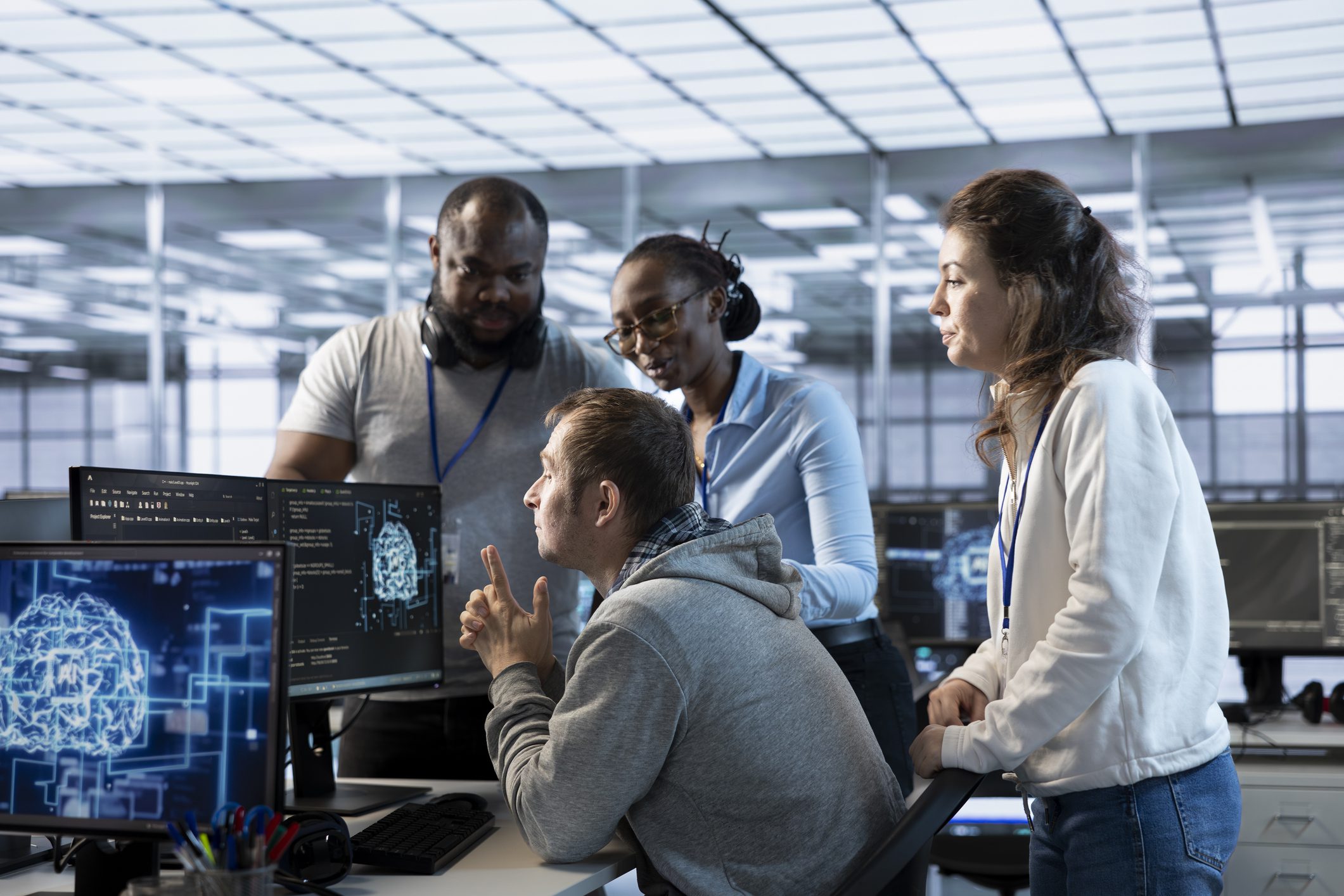 Colleagues analyzing software on monitors